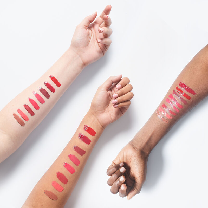 Product arm swatches of Mary Kay Supreme Hydrating Lipstick in all shades on ivory, medium and deep skin toned arms.