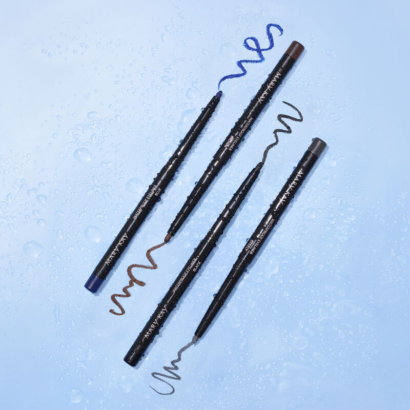 Uncapped Mary Kay Waterproof Eyeliner in Black, Steely, Blue and Brown covered in water droplets against blue background