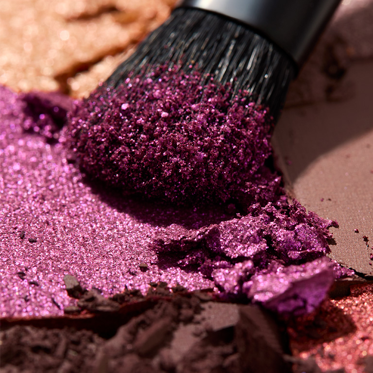 Eyeshadow brush and texture rub of deep purple eyeshadow shade